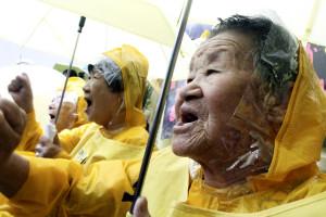 Former comfort women who served the Japanese Army as sexual slaves during World War II, shout a slogan in a rally before Korean Liberation Day of Aug. 15, which marks the end of Japanese colonial rule in 1945, in front of the Japanese Embassy in Seoul, South Korea, Wednesday, Aug. 12, 2009. They demanded from the Japanese government an official apology and financial compensation.(AP Photo/Ahn Young-joon)